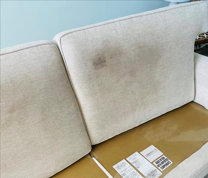 white couch with black and gray stains